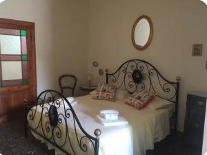 a bedroom with a bed with a wrought iron frame at Via Roma 131 in Montevarchi