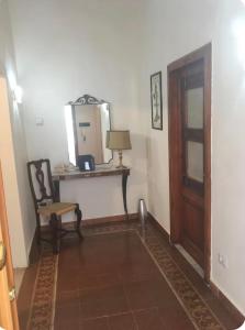 a hallway with a table and a chair and a mirror at Via Roma 131 in Montevarchi