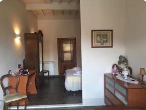a bedroom with a bed and a desk and a dresser at Via Roma 131 in Montevarchi