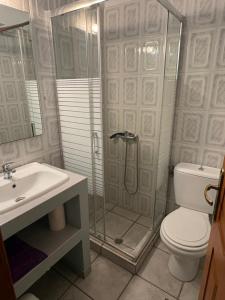 a bathroom with a shower and a toilet and a sink at Zannikos Rooms in Ermoupoli +27 photos