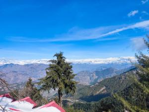 a view of a mountain range with a tree and tents at M S Resort Dalhousie, Near mall road Gandhi Chowk Dalhousie in Dalhousie +14 photos