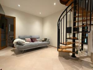 a living room with a couch and a staircase at Villa su in Roquebrune-Cap-Martin