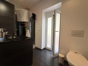 a bathroom with a sink and a toilet and a mirror at Villa su in Roquebrune-Cap-Martin