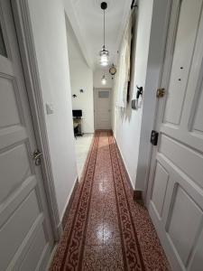 a hallway with a door and a rug on the floor at Casa Shala in Tunis