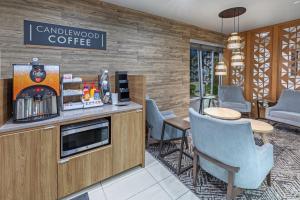 a coffee shop with chairs and a counter at Candlewood Suites - Muskogee by IHG in Muskogee