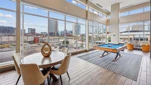 a large room with a pool table and chairs at Sentral SoBro in Nashville