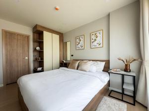 a bedroom with a large white bed in it at Comfortable 2Bdr Bangtao Space Condo in Ban Thalat Choeng Thale +25 photos