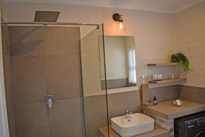 a bathroom with a glass shower and a sink at 1009 Studio Apartment Pont de Val in Parys +1 photo
