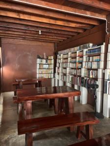 a library with wooden tables and shelves of books at Namosototie in Ranong +28 photos