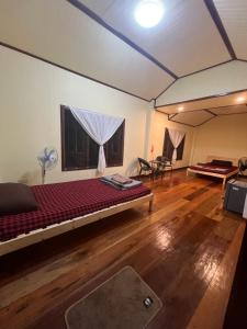 a room with a large bed in a tent at Namosototie in Ranong