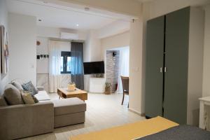 a living room with a couch and a tv at Mediterranean in Preveza