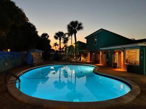 a large blue swimming pool next to a house at Sand Dune Shores in Palm Beach Shores +11 photos