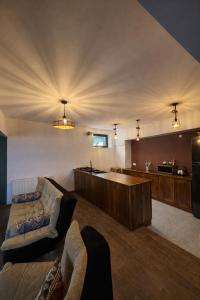 a large living room with a couch and a tub at Ortevani Guest House in Kvareli