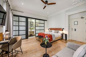 a bedroom with a bed and a living room at Hotel Boutique Casa Romana Villa in Seville