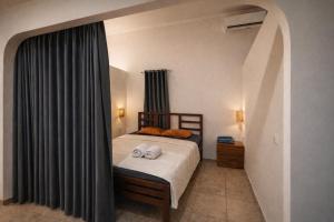 a bedroom with a bed with two towels on it at Wanderlust Hostel - Highest Privacy Hostel In Kuta - Big Clear Pool - Fast Internet in Kuta Lombok