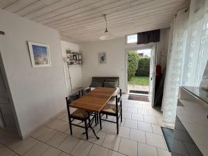 a dining room with a wooden table and chairs at Maison Ustou46 in Cahors