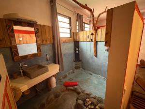 a bathroom with a tub with a sink and a shower at Matilona in Sainte-Rose +19 photos