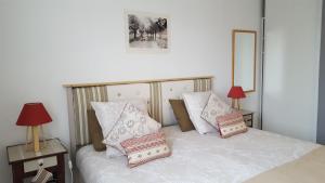 a bedroom with a white bed with pillows on it at Provence Luberon Goult Gite Mafasuza in Goult