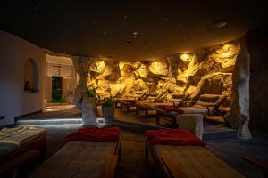 a room with couches and a rock wall at Hotel Amselgrundschlößchen in Kurort Rathen
