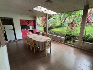 a kitchen and dining room with a table and chairs at Matilona in Sainte-Rose