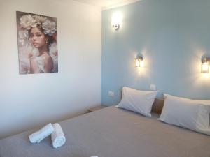 a bedroom with a bed with a picture on the wall at Thalassoudis-House 2 in Agios Nikolaos