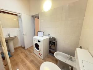 a bathroom with a washing machine and a sink at Nuvola di Parma// del Ducato 1 in Parma