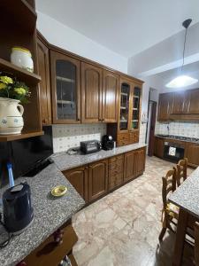 a kitchen with wooden cabinets and a counter top at Brezza Marina in Gallico