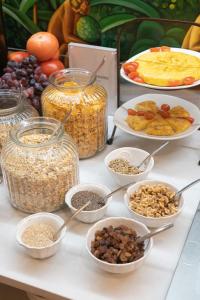 a table topped with bowls of nuts and other food at Hotel Boutique Casa Romana Villa in Seville +30 photos