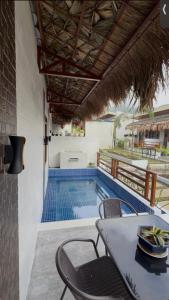 a table and chairs next to a swimming pool at Casa Sereno Spring Resort in Irosin
