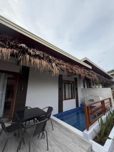a house with a patio with a table and chairs at Casa Sereno Spring Resort in Irosin