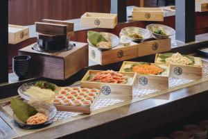 a buffet with different types of food in wooden boxes at Hakodate Hotel Banso in Hakodate