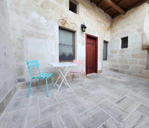 a patio with chairs and a table in a building at Key of Cappadocia - House of Beautiful Horses in Avanos