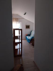 a room with a ladder leading to a bedroom at Studio apartman u ruralnom okruženju in Donji Karin +5 photos
