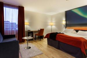a hotel room with a bed and a chair at Scandic Alta in Alta