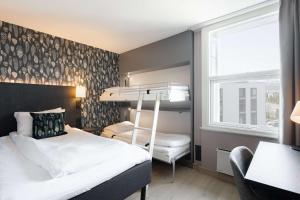 a bedroom with a bunk bed and a desk at Scandic Alta in Alta +38 photos