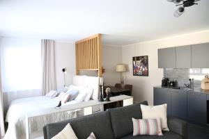 a living room with a bed and a couch at Lamira Serviced Apartments Zurich City in Zurich