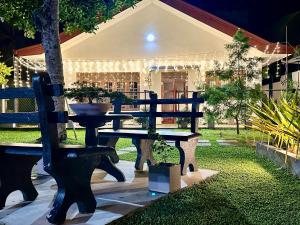 a bench sitting in front of a house with lights at Villa La Mama Beruwala in Beruwala