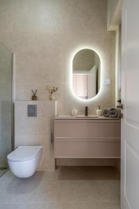 a bathroom with a white toilet and a mirror at Palmotić Heritage Suites - Main Square - FREE Parking in Zagreb +43 photos