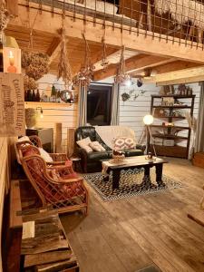 a living room with a couch and a table at Chalet de la Folie in Martelange