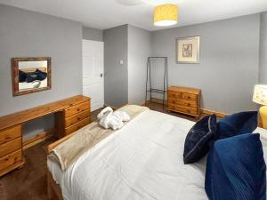 a bedroom with a large bed and a mirror at Orcadians in Sellindge +9 photos