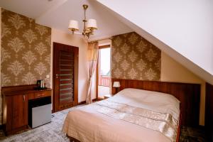 a bedroom with a large bed and a staircase at Aldian Pokoje Gościnne in Szczyrk