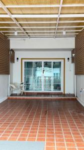 a large empty room with a large window and a table at Mnp home in Chiang Rai