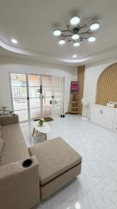 a living room with a couch and a table at Mnp home in Chiang Rai