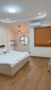 a bedroom with a large bed and a window at Mnp home in Chiang Rai