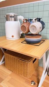 a table with a blender and plates on it at Mnp home in Chiang Rai