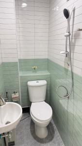 a bathroom with a shower and a toilet and a sink at Mnp home in Chiang Rai +45 photos