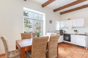 a kitchen with a wooden table and chairs at Lodge an der Muehle in Bredstedt