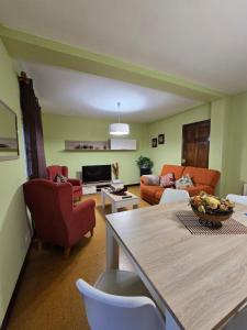 a living room with a couch and a table at O Parrandeiro in Padrón