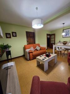 a living room with a couch and a table at O Parrandeiro in Padrón +18 photos