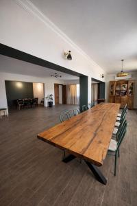 a large wooden table in a room with chairs at Ortevani Guest House in Kvareli